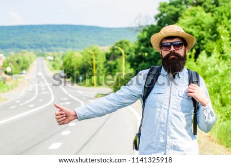 Hitchhiker with special gesture. Man try stop car thumb up. Hitchhiking one of cheapest ways traveling. Hitchhikers risk being picked up by someone who is unsafe driver or personally dangerous.