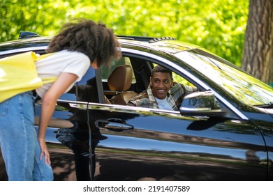 Hitchhiker Talking To A Car Driver On The Road