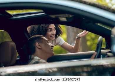 Hitchhiker Talking To A Car Driver On The Road