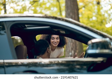 Hitchhiker Talking To A Car Driver On The Road