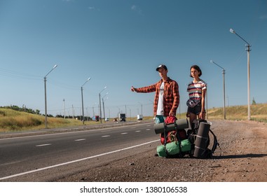 Hitchhiking Couple. Backpackers On Road.