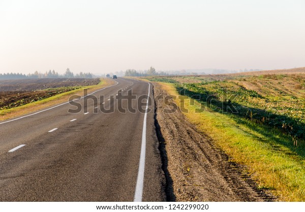 hitchhiking, empty road, freedom of choice. car on\
the highway on a sunny\
day.