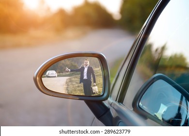 Hitchhiking Man In The Rearview Mirror