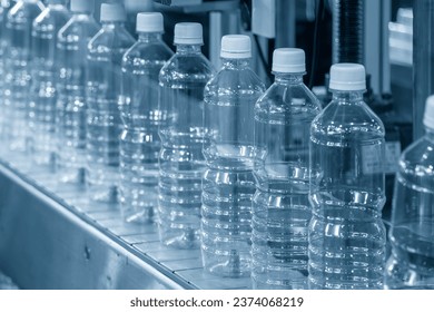 The hi-technology of drinking water manufacturing process. The  empty drinking water bottles  on the conveyor belt for filling process.  - Powered by Shutterstock