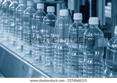 The hi-technology of drinking water manufacturing process. The  empty drinking water bottles  on the conveyor belt for filling process. 