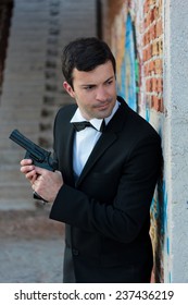 Hitman In Tuxedo Holding A Gun