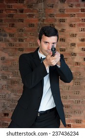 Hitman In Tuxedo Holding A Gun