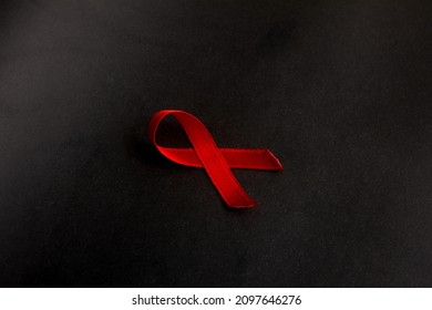 HIV AIDS Awareness Symbol Red Ribbon On Black Background