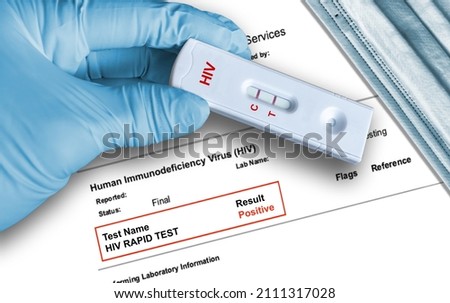 HIV positive antigen test result by using rapid self testing device held by hand in medical glove with medical face mask in background. 