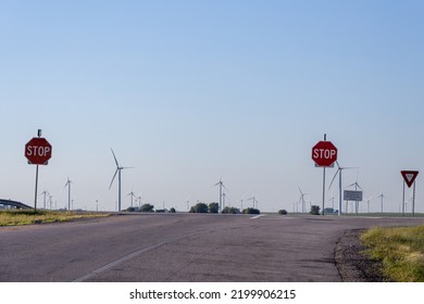 hiway road and stop signs. wind turbines farm. renewable energy