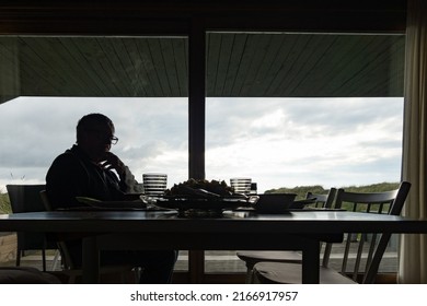 Hjorring, Denmark June 10, 2022 A Senior Man Sits At A Dinner Table Alone