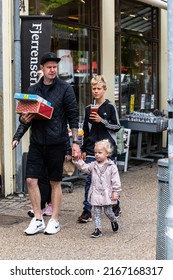 Hjorring, Denmark June 8, 2022 A family walking down the street.