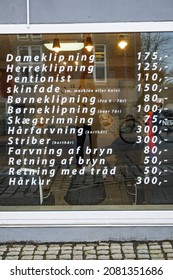 Hjorring, Denmark Nov 24, 2021 A hair salon window with prices in Danish kronor.