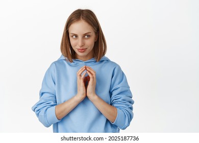 Hmm interesting. Young woman scheming smth, looking aside with smug face, steeple fingers cunning, has devious evil genius plan, stare mysterious at empty space, white background