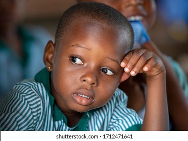 Ho, Asogli / Ghana - September 15, 2018: A serious young student leans against her hand in class in school in rural Ghana, West Africa.