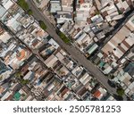 Ho Chi Min City, Vietnam District eight from top down aerial view featuring  rooftops, dense urban housing, streets and alleyways.