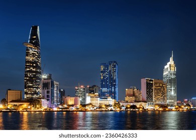 Ho Chi Minh City skyline and the Saigon River. Amazing night view of skyscraper and other modern buildings at downtown. Ho Chi Minh City is a popular tourist destination of Vietnam. Scenic cityscape.