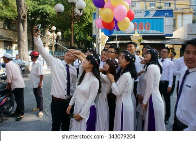 HO CHI MINH CITY, VIET NAM- NOV 24: Crowd Of Vietnamese Student In Traditional Dress, Ao Dai, Shooting For Yearbook At Saigon Notre Dame Cathedral, Vietnam, Nov 24, 2015