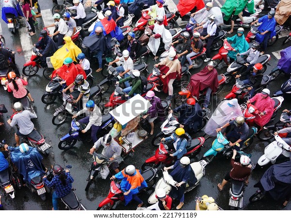 HO CHI MINH CITY, VIET NAM- OCT 6: Impression,\
colorful scene of Asia city in rush hour after rain evening, crowd\
of Vietnamese people wear raincoat, on motorbike, crowded on\
street, Vietnam, Oct 6, 2014