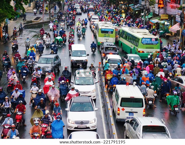 HO CHI MINH CITY, VIET NAM- OCT 6: Impression,
colorful scene of Asia city in rush hour after rain evening, crowd
of Vietnamese people wear raincoat, on motorbike, crowded on
street, Vietnam, Oct 6, 2014