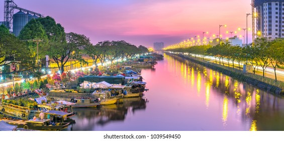 Ho Chi Minh City, Vietnam - February 14, 2018: Sunset on boat dock at  flower market along canal wharf. This is place where Farmers sell apricot blossom and other flowers on Lunar New Year in Vietnam