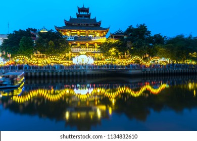 Ho Chi Minh City, Vietnam - May 28, 2018: Night scene architecture temple along river at night decorated with bright lights, flags, flowers celebrate the Buddha's birthday in Ho Chi Minh City, Vietnam