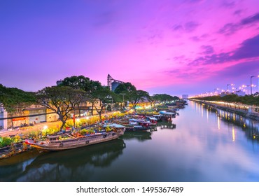 Ho Chi Minh City, Vietnam - February 3rd, 2019: Sunset boat dock flower market along canal wharf. This is place farmers sell apricot and other flowers on Lunar New Year in Ho Chi Minh city, Vietnam