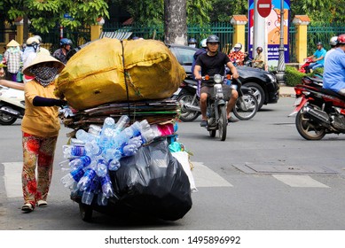 HO CHI MINH CITY, VIETNAM - DECEMBER 28. 2014: Overloaded motorbike with collected plastic bottles in traffic of Saigon