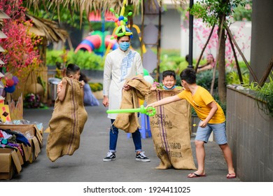 Ho Chi Minh City, Vietnam - January 20th 2021: Children Play Bag Jumping Game( Running Inside The Bag)