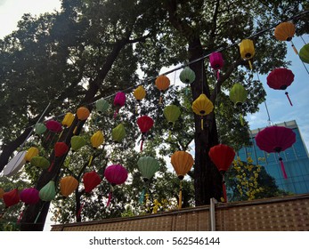 Ho Chi Minh city, Vietnam - Jan 22, 2016: : Atmosphere of springtime with colorful scene on Saigon street, Vietnamese woman in ao dai, posing beside flower to take photo on Tet holiday