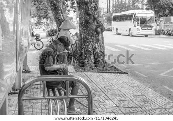 Ho\
Chi Minh City, Vietnam - September 1, 2018: an undefined man is\
getting everything ready before getting on the\
bus.