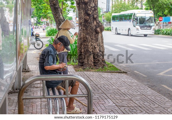 Ho\
Chi Minh City, Vietnam - September 1, 2018: an undefined man is\
getting everything ready before getting on the\
bus.