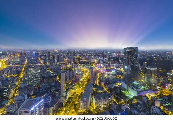 Ho Chi Minh City, Vietnam - April 11, 2017: High\
view Saigon skyline when sunset urban areas colorful and vibrant\
cityscape of downtown with traffic light trails by night in Ho Chi\
Minh city, Vietnam