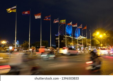 Ho Chi Minh, Vietnam - April 6, 2019: Multinational Flags In ASEAN Community Country In The Night Time At Saigon With People, Cars And Motorcycles On The Road.