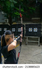 Ho Chi Minh, Vietnam - March 20 2022: A girl practicing archery at an outdoor club