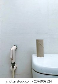 Ho Chí Minh City, Vietnam - December 27  2021: A Empty Paper Towel Rolls And A Hose  In The Bathroom