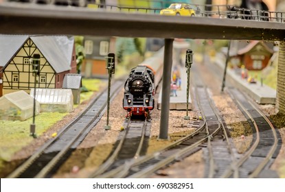 HO Model Train Powered By Steam Engine Replica Entering The Station