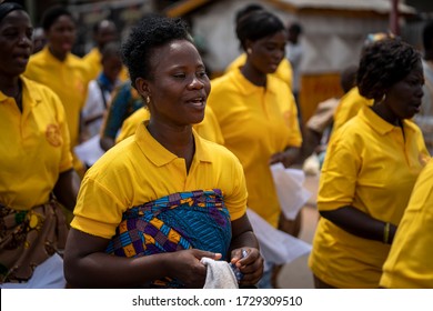 Ho, Volta / Ghana - September 14, 2018: A women's groupie colorful yellow shirts march in a procession during a festival in Ghana, West Africa.