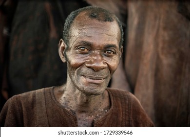 Ho, Volta / Ghana - September 14, 2018: An Old Weathered Ghanaian Man Poses For Picture In A Rural Village In Ghana, West Africa.