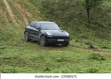 Hoa Binh, Viet Nam - March 27, 2015: Porsche Macan 2015 car running on the mountain road in Vietnam