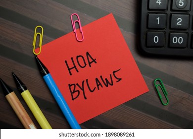 HOA Bylaws Write On Sticky Notes Isolated On Wooden Table.