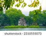 Hoan Kiem Lake ( Ho Guom) or Sword lake in the center of Hanoi with clear sky. Hoan Kiem Lake is a famous tourist place in Hanoi. Travel and landscape concept. Selective focus.