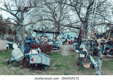 Hoarding disorder. Neglected allotment garden of people who suffers from compulsive hoarding, littered with trash and other items. Messy, Compulsive hoarding disorder concept - stuff in the garden	 - Shutterstock ID 2045929172