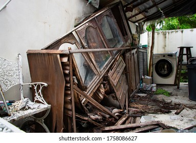 Hoarding Disorder Stay Home In Abandoned Unorganized Kitchen Messy With Broken Ruined Wooden Old Vintage Antique Cupboard Collapse Cabinets Unhygienic Glasses And Dishes, Dirty Laundry Washing Machine