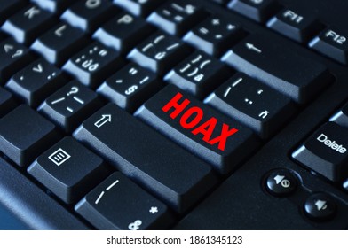 Hoax word on red keyboard button. Computer keyboard key with danger sign with words Internet Hoax, Danger of Internet Hoax.