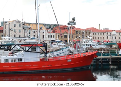 Hobart, Tasmania Australia - 17 May 2022 - fishing boats and yachts in Sullivan Cove on Salamanca Harbour Wharf in the Tasmania with historic buildings in background