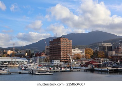 Hobart, Tasmania Australia - 17 May 2022 - fishing boats and yachts in Sullivan Cove on Salamanca Harbour Wharf in Tasmania with historic buildings in background and view of Hobart city