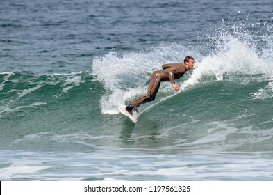 Hobart, Tasmania, Australia. October 2018. Surfers in action at Clifton Beach SE of Hobart in Tasmania.