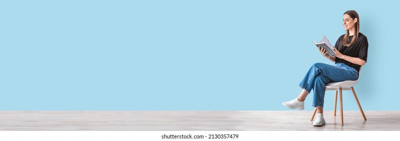 Hobbies And Activities. Happy Young Caucasian Woman Reading Book, Sitting On Chair, Blue Studio Wall, Panorama With Copy Space. Millennial Lady Enjoying Interesting Story, Studying For Exam, Mockup