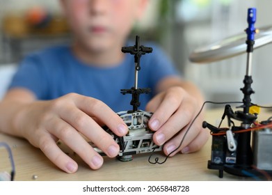 Hobbies For Advanced Smart Kids. Young Inventor Boy Carefully Assembling Drone